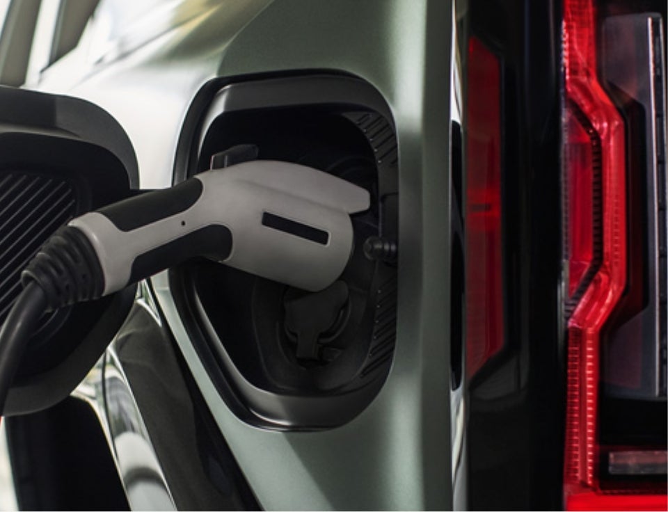Close up of charging port with charger plugged in on a GMC Hummer EV SUV - Blue Diamond GMC in Price UT